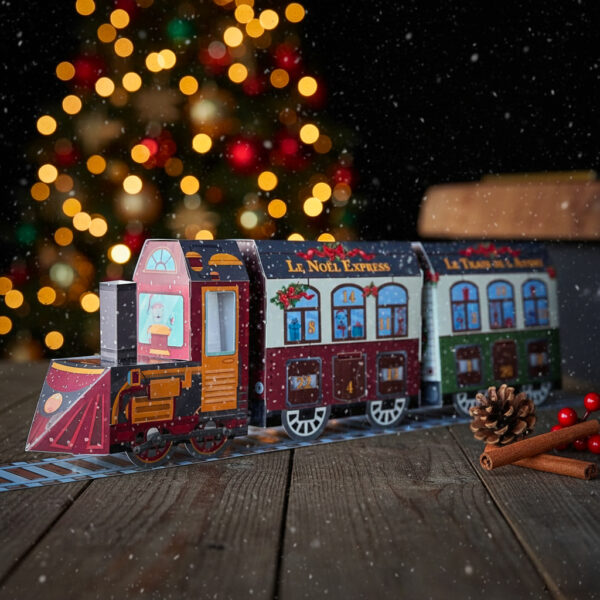 calendrier-avant-noel-train Calendrier de l’Avent en forme de train, garni de chocolats artisanaux Papa Gâteau, présenté dans un décor festif de Noël.